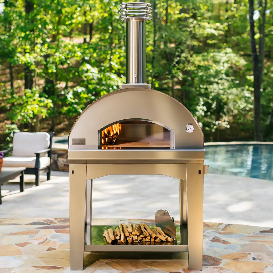 The manufacturer shows a cart-supported Mangiafuoco; cart, finish and stone choices vary by package.