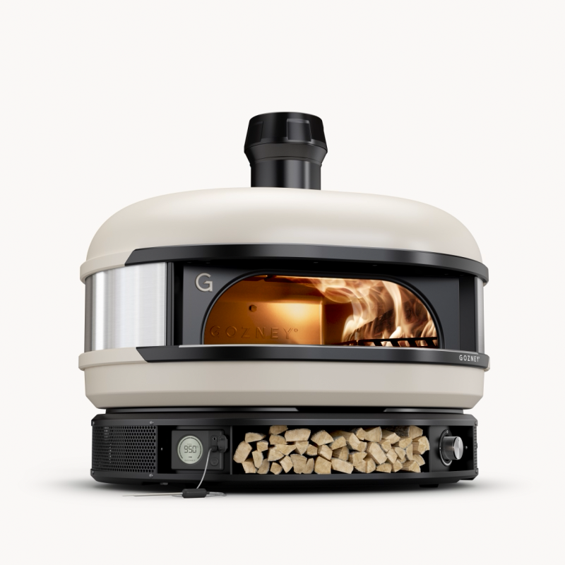 Gozney Dome earlier generation in Bone with an open wood flame; manufacturer marketing frame, photography or render status uncertain